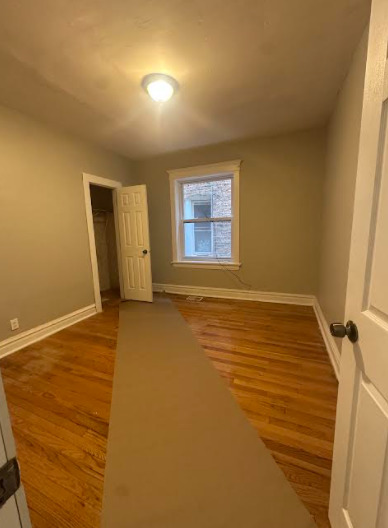 7704 South Aberdeen Street, Unit 1S Chicago, IL 60620 - Photo 6 of 14 a view of an empty room and window