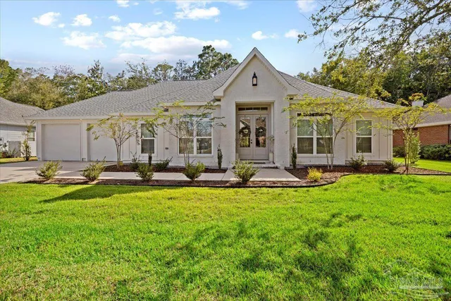 a view of a house with swimming pool and furniture