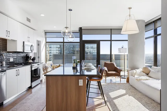 a kitchen with stainless steel appliances granite countertop a sink refrigerator and microwave