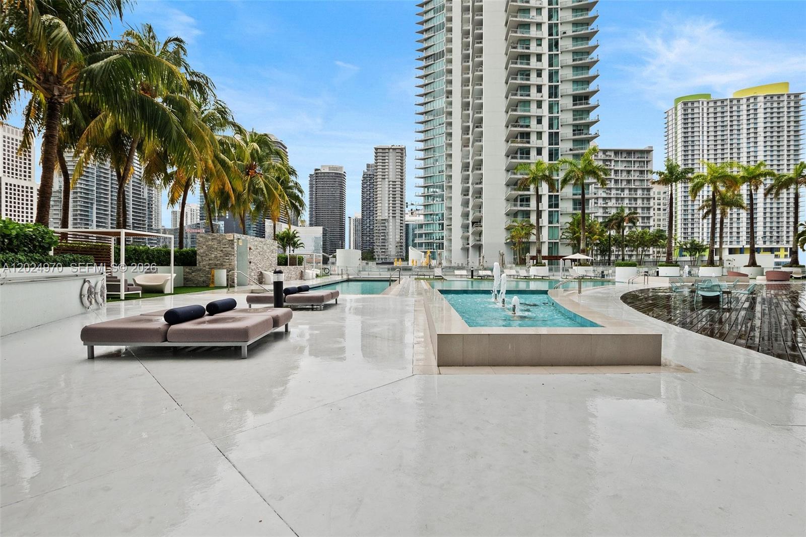 90 Southwest 3rd Street, Unit 3810 Miami, FL 33130 - Photo 30 of 45 a swimming pool with outdoor seating and a yard