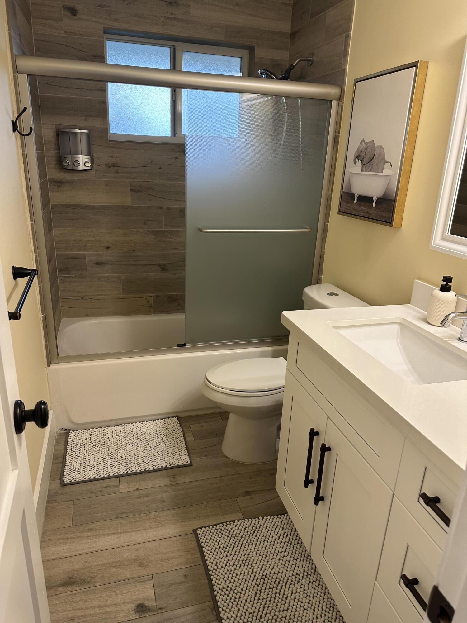 5111 Northeast 27th Terrace Lighthouse Point, FL 33064 - Photo 12 of 23 a bathroom with a sink and a mirror