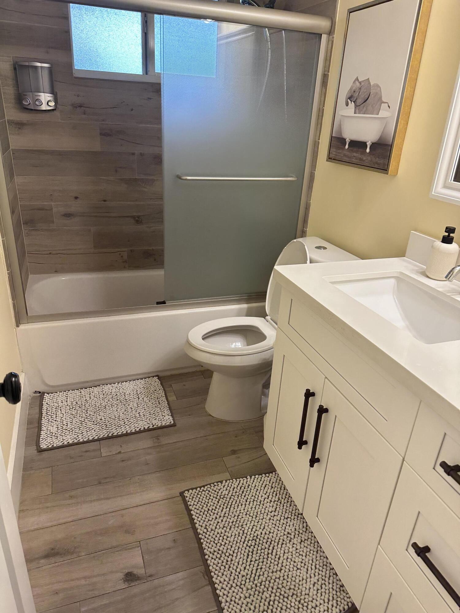 5111 Northeast 27th Terrace Lighthouse Point, FL 33064 - Photo 18 of 23 a bathroom with a sink toilet and shower