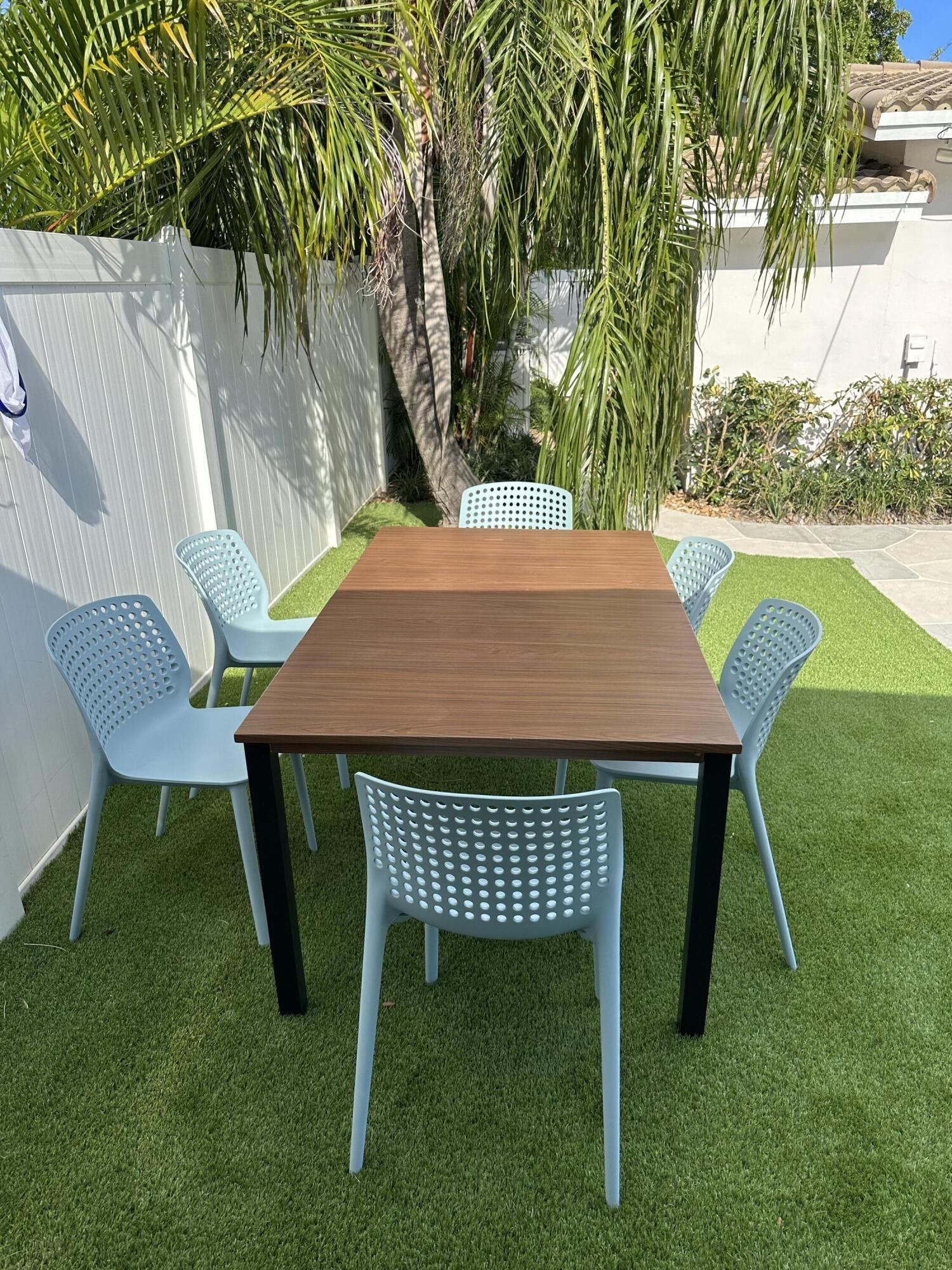 5111 Northeast 27th Terrace Lighthouse Point, FL 33064 - Photo 7 of 23 a patio with table and chairs