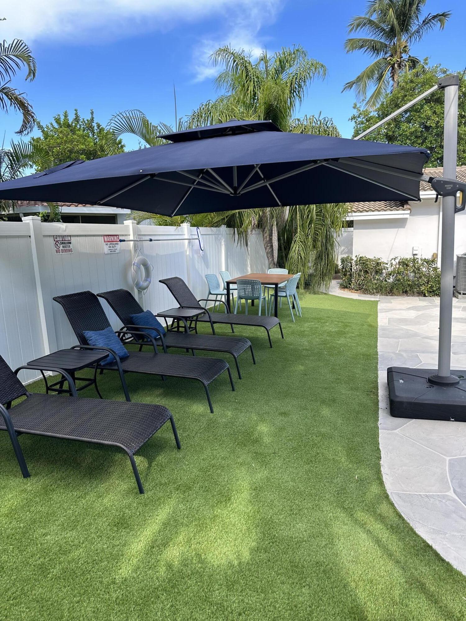 5111 Northeast 27th Terrace Lighthouse Point, FL 33064 - Photo 10 of 23 an outdoor sitting area with golf table and chairs