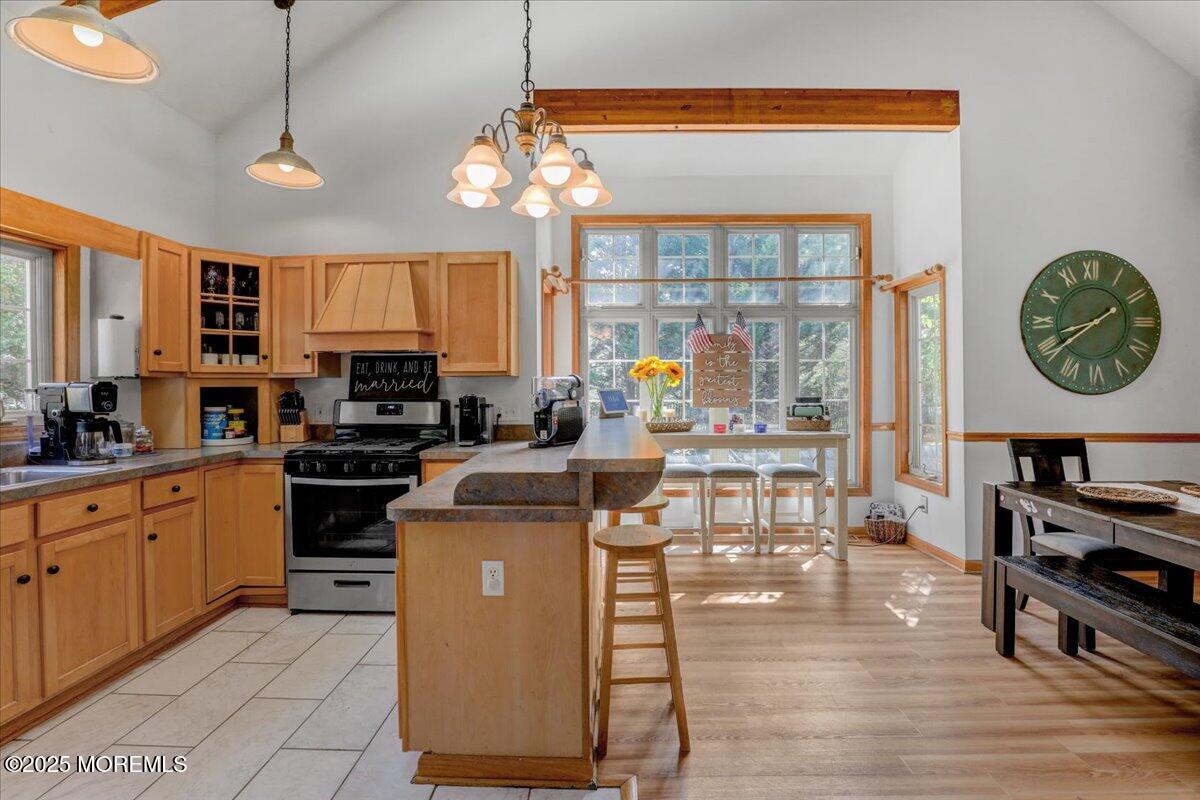 9 Main Street Cream Ridge, NJ 08514 - Photo 12 of 30 a open kitchen with stainless steel appliances granite countertop a stove top oven a refrigerator a dining table and chairs with wooden floor