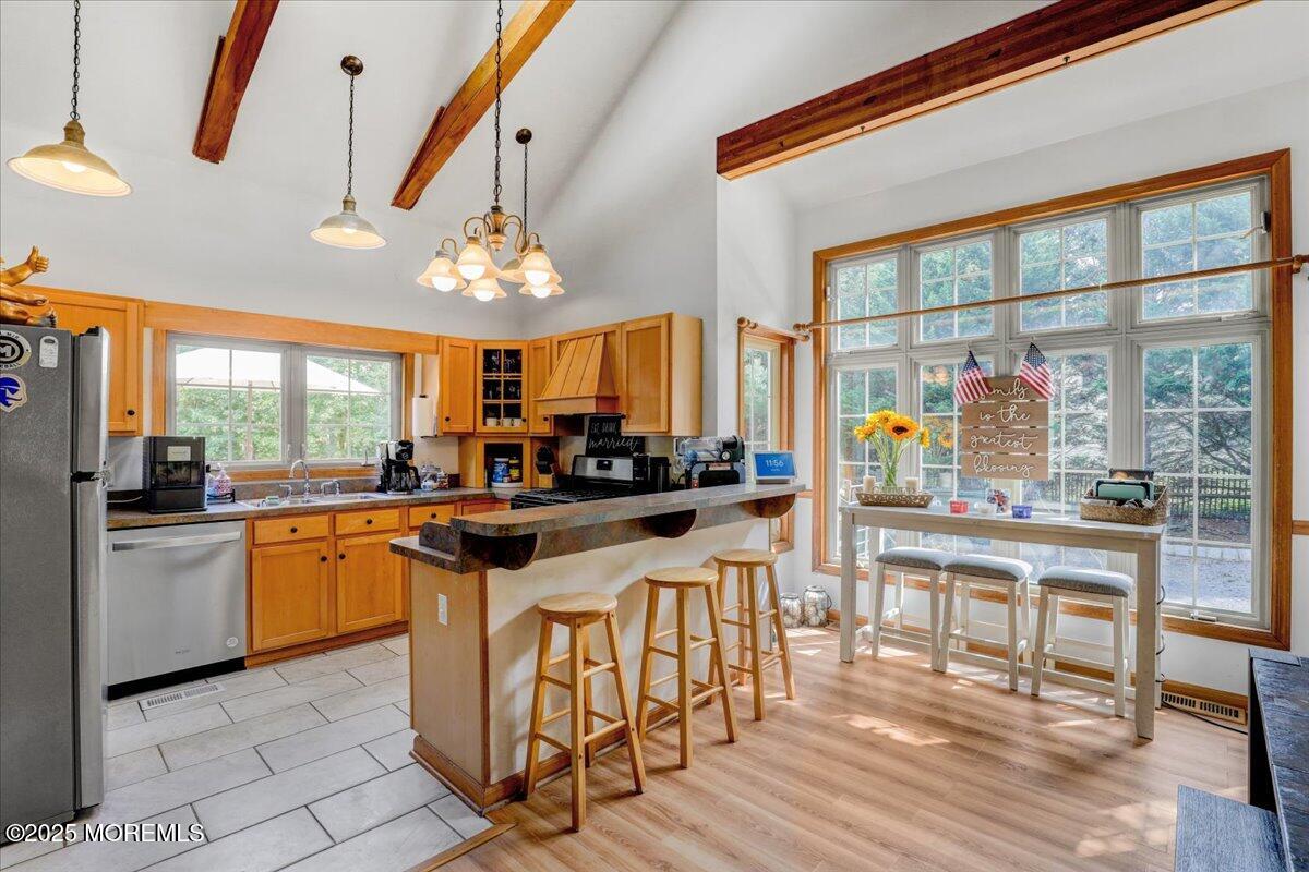 9 Main Street Cream Ridge, NJ 08514 - Photo 13 of 30 a kitchen with stainless steel appliances granite countertop a stove and white cabinets with wooden floor