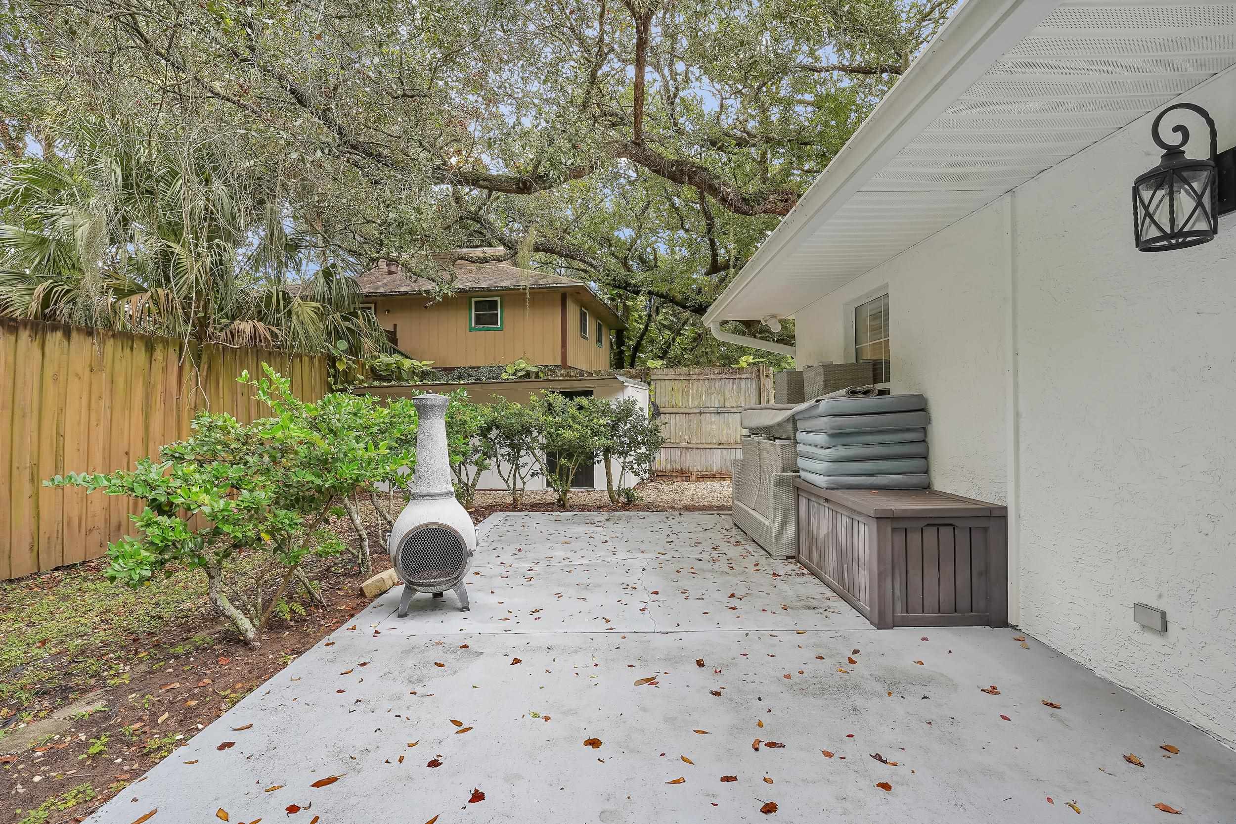 308 A Street St. Augustine, FL 32080 - Photo 11 of 46 a backyard of a house with wooden floor chairs and plants