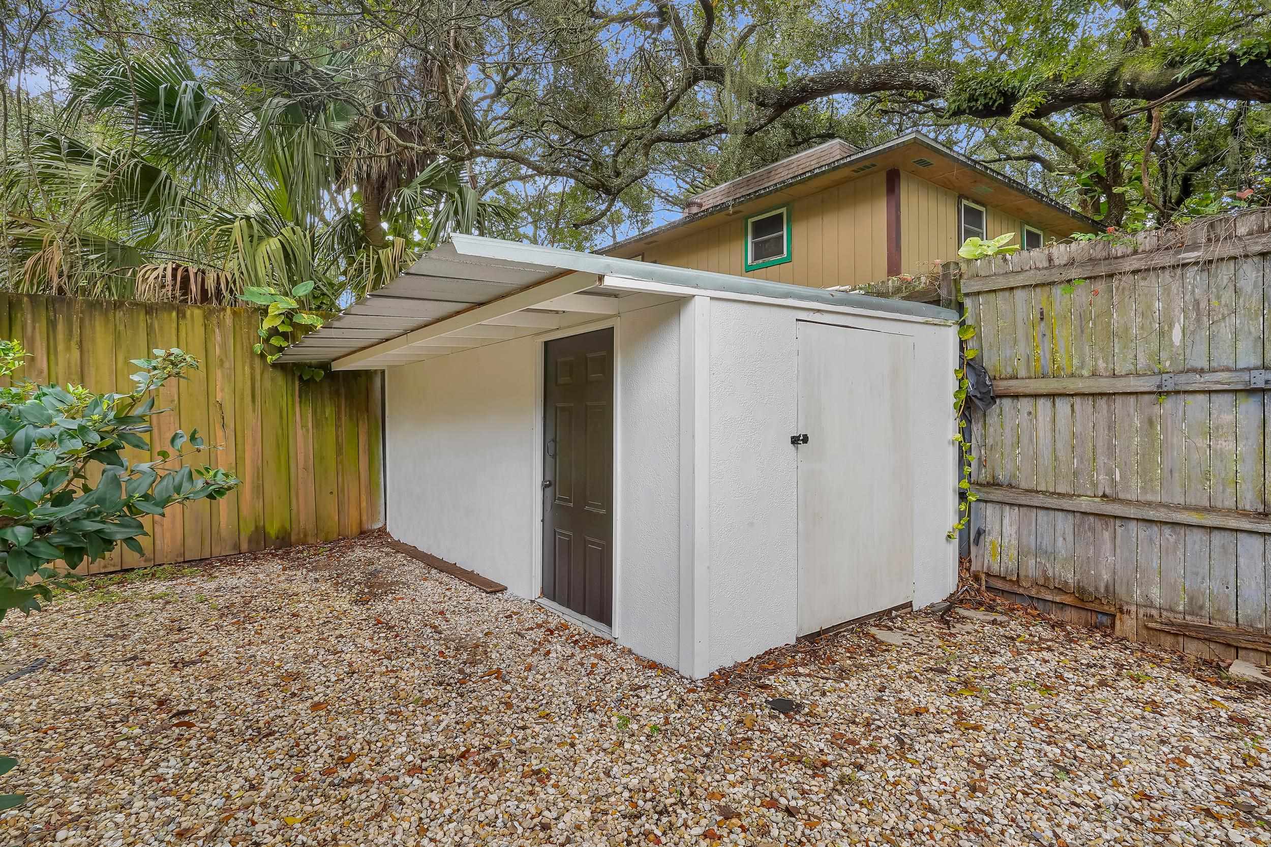 308 A Street St. Augustine, FL 32080 - Photo 13 of 46 a view of a wooden house with a small yard