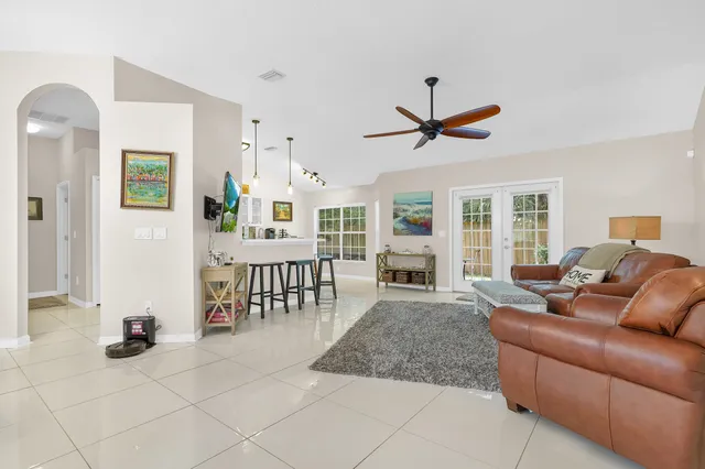 a living room with furniture a flat screen tv and a table