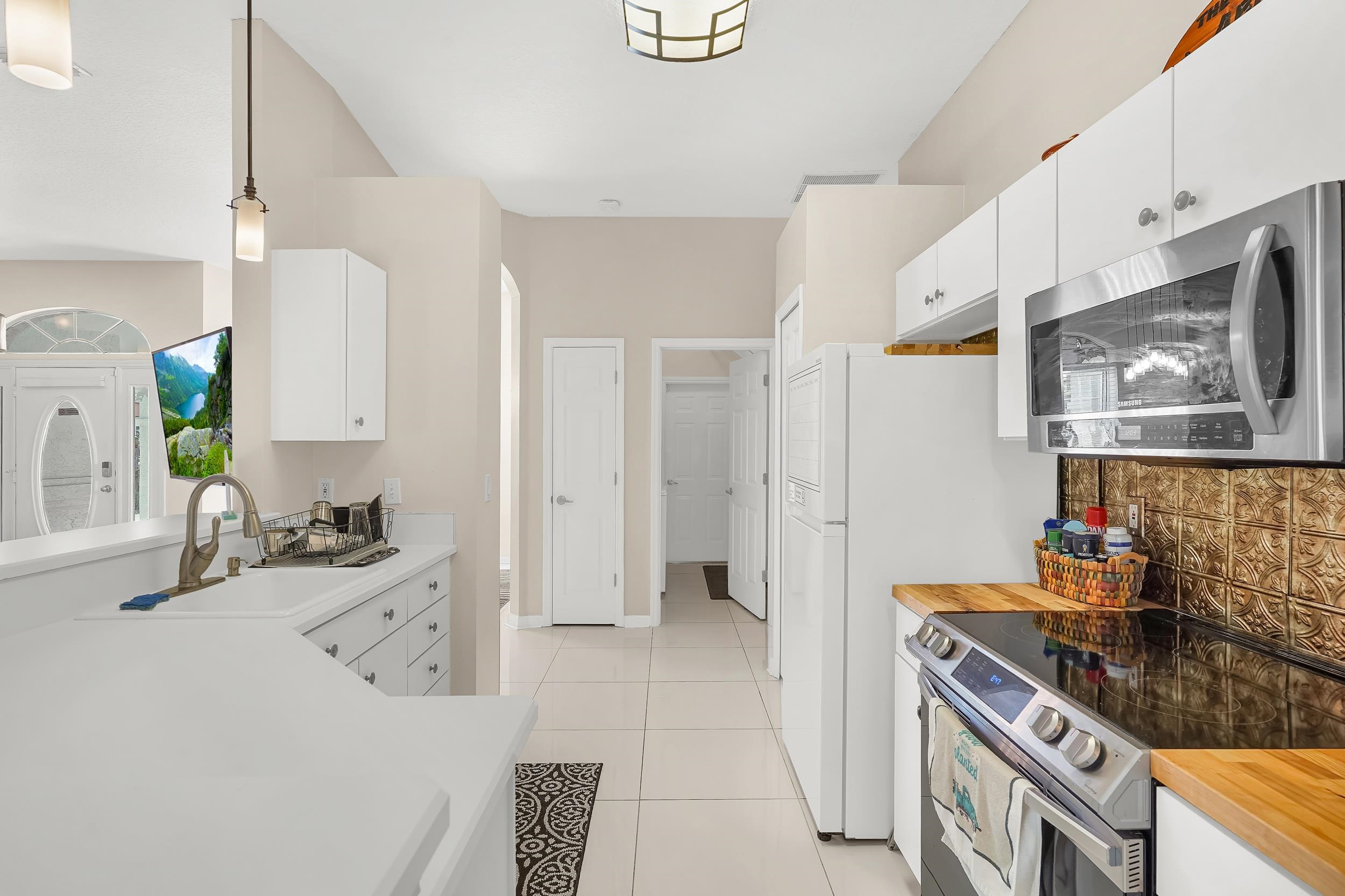 308 A Street St. Augustine, FL 32080 - Photo 22 of 46 a kitchen with stainless steel appliances a stove a sink and a refrigerator