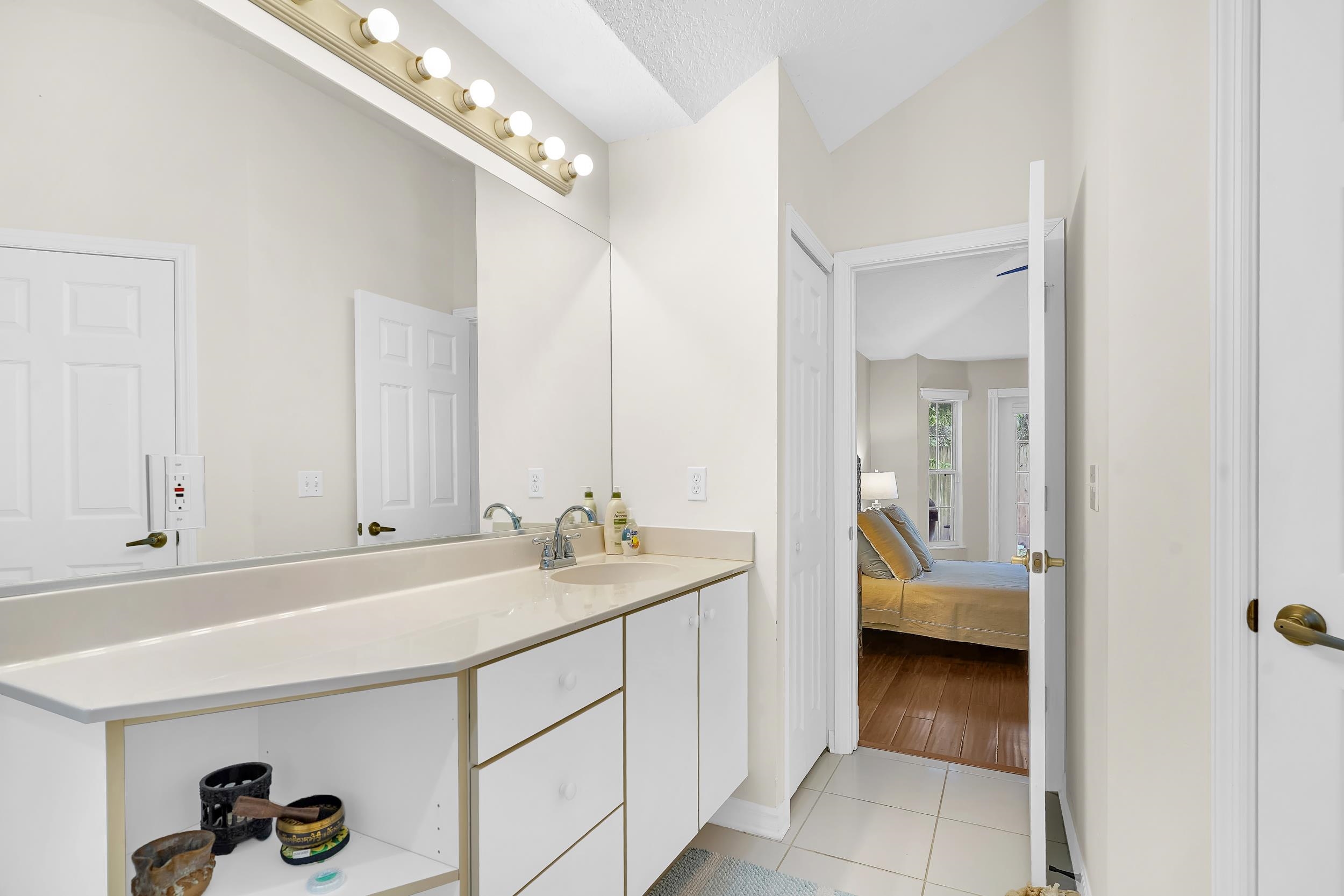 308 A Street St. Augustine, FL 32080 - Photo 36 of 46 a en suite bathroom with a sink and a mirror