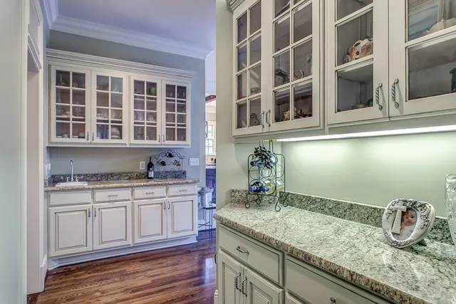 a kitchen with granite countertop a sink and cabinets