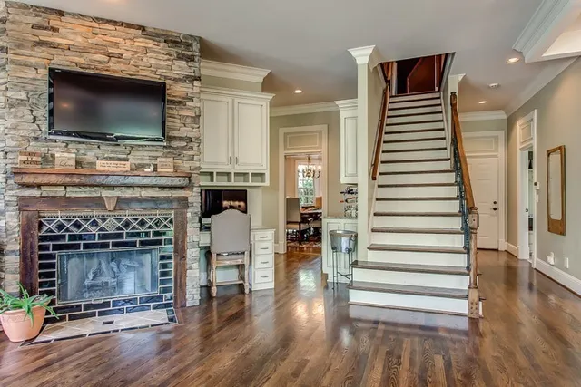 a living room with fireplace and flat screen tv