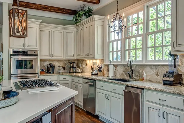 a kitchen with a sink stove and microwave