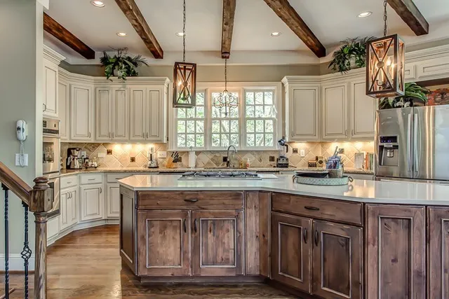 a kitchen with kitchen island granite countertop a sink window and cabinets