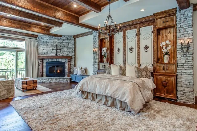 a spacious bedroom with a bed and a fireplace