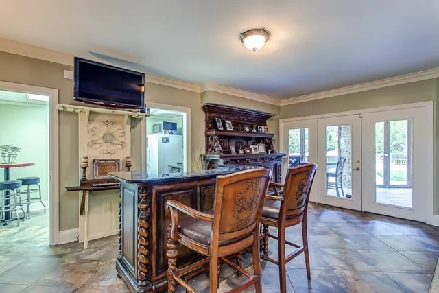 a living room with furniture a lamp and a chandelier