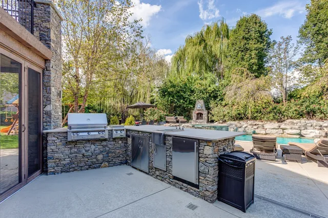 a view of an outdoor dining space with a table and chairs