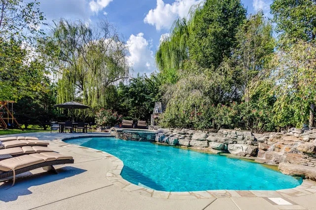 a view of a dining table and chairs under an umbrella