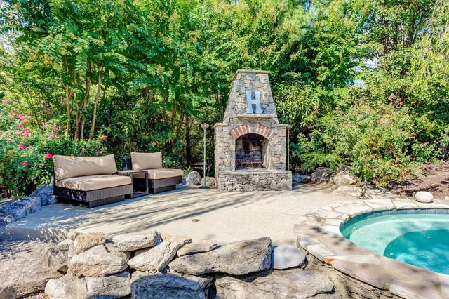 a backyard of a house with table and chairs