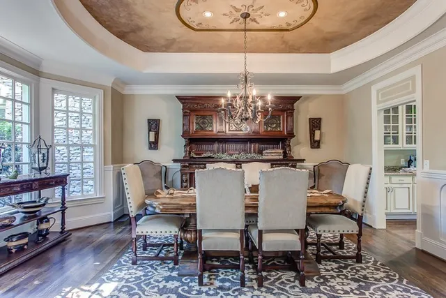 a view of a dining room with furniture wooden floor and chandelier