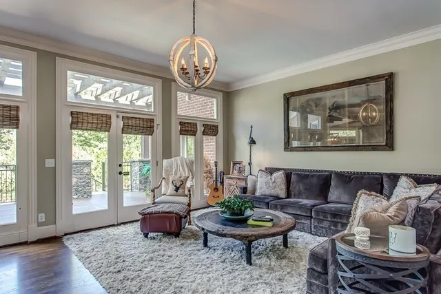 a living room with furniture chandelier and window