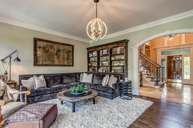 a living room with furniture a rug and a window