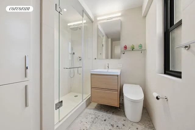 a bathroom with a toilet sink and a mirror