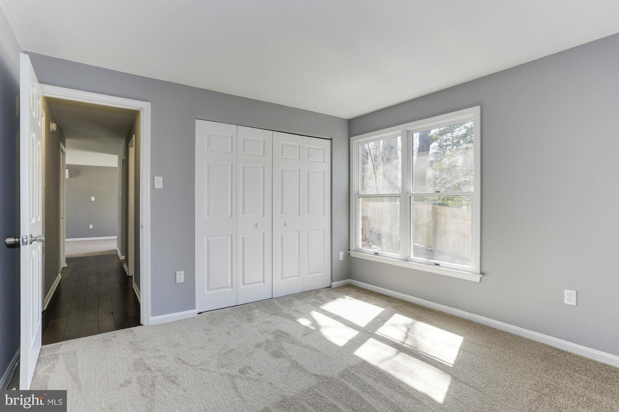 6023 Maple Road St. Leonard, MD 20685 - Photo 12 of 30 a view of an empty room with wooden floor and a window