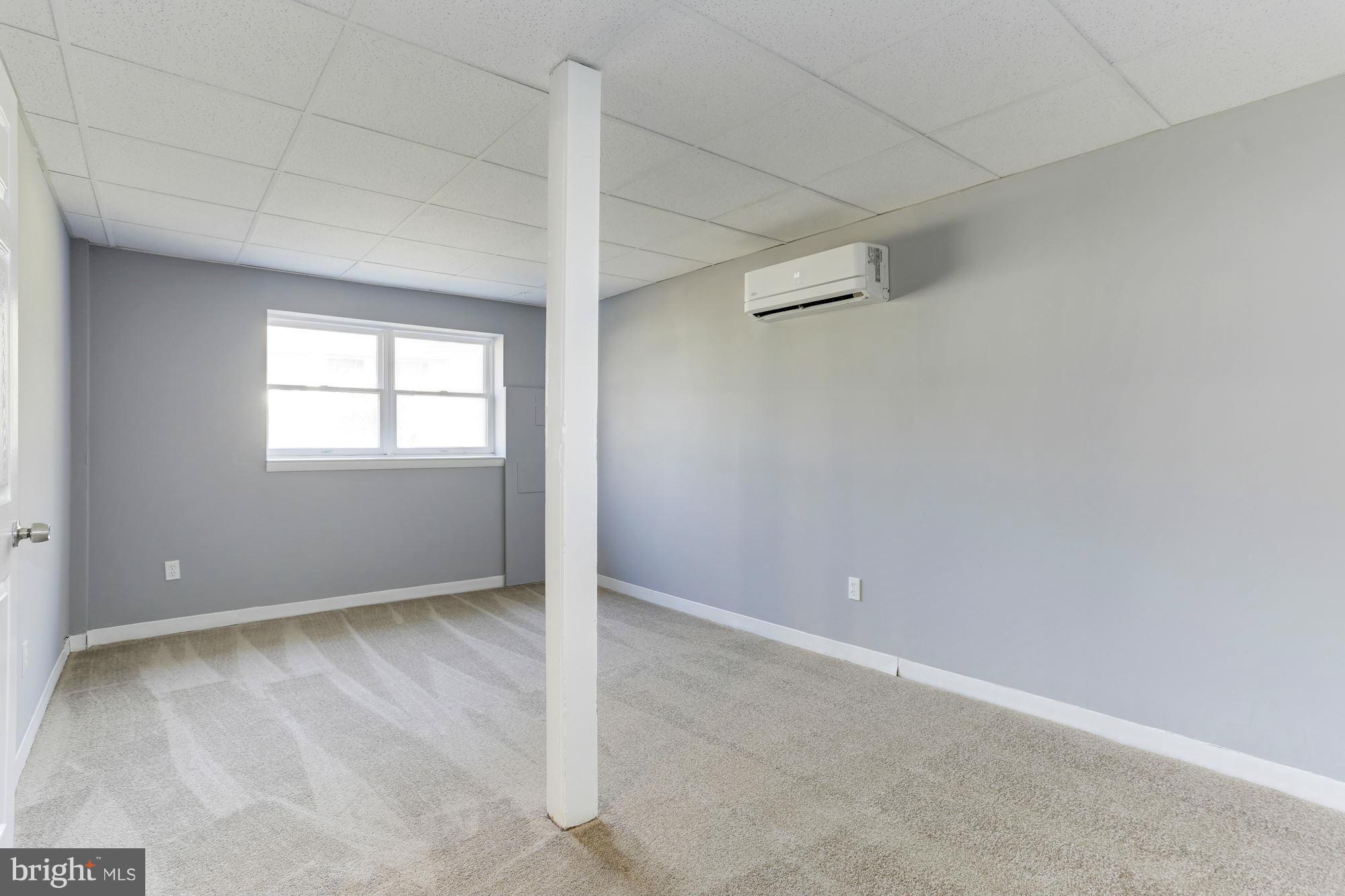 6023 Maple Road St. Leonard, MD 20685 - Photo 21 of 30 an empty room with windows and entrance to other room