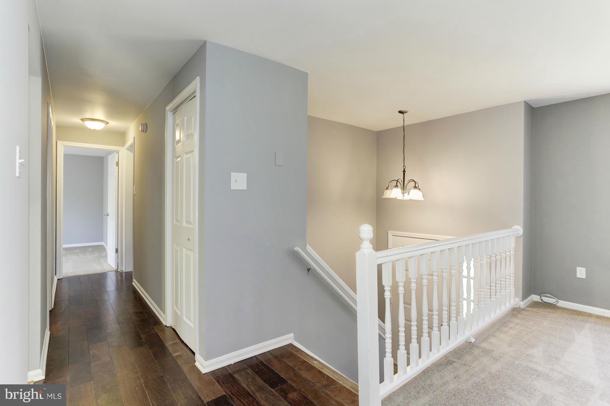 6023 Maple Road St. Leonard, MD 20685 - Photo 6 of 30 a view of a hallway view with wooden floor and staircase