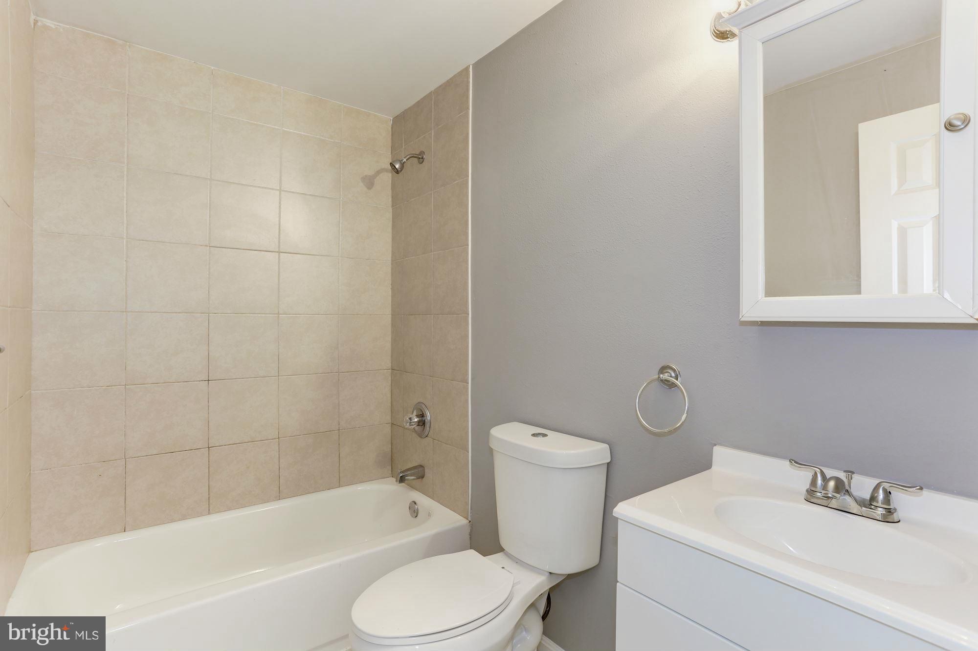 6023 Maple Road St. Leonard, MD 20685 - Photo 10 of 30 a white toilet sitting next to a bath tub