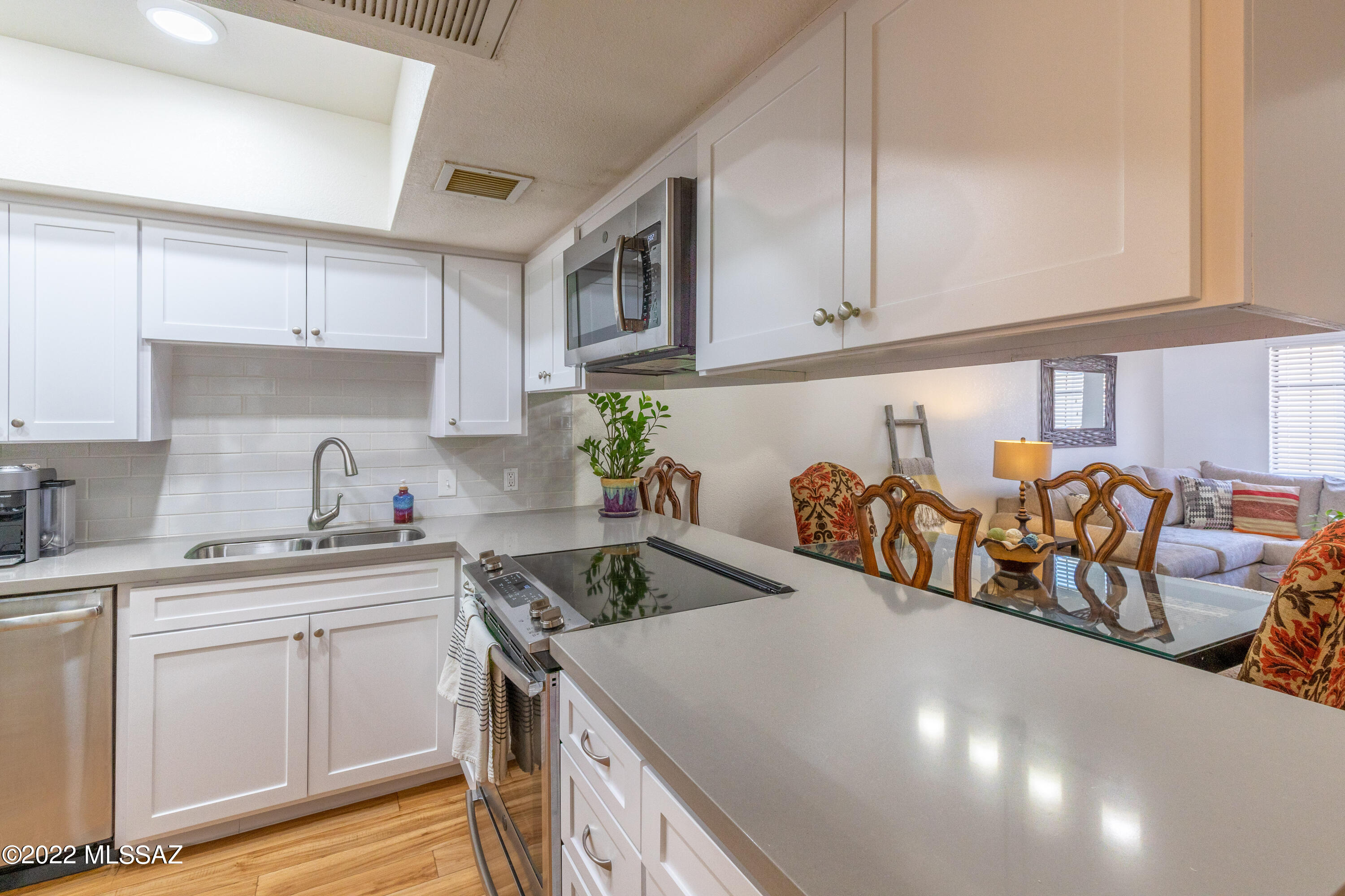 1200 East River Road, Unit F69 Tucson, AZ 85718 - Photo 8 of 22 a kitchen with stainless steel appliances granite countertop a sink a stove and cabinets
