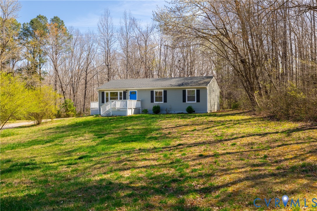 9813 Colemans Lake Road Ford, VA 23850 - Photo 1 of 38 a view of a house with a big yard and large trees