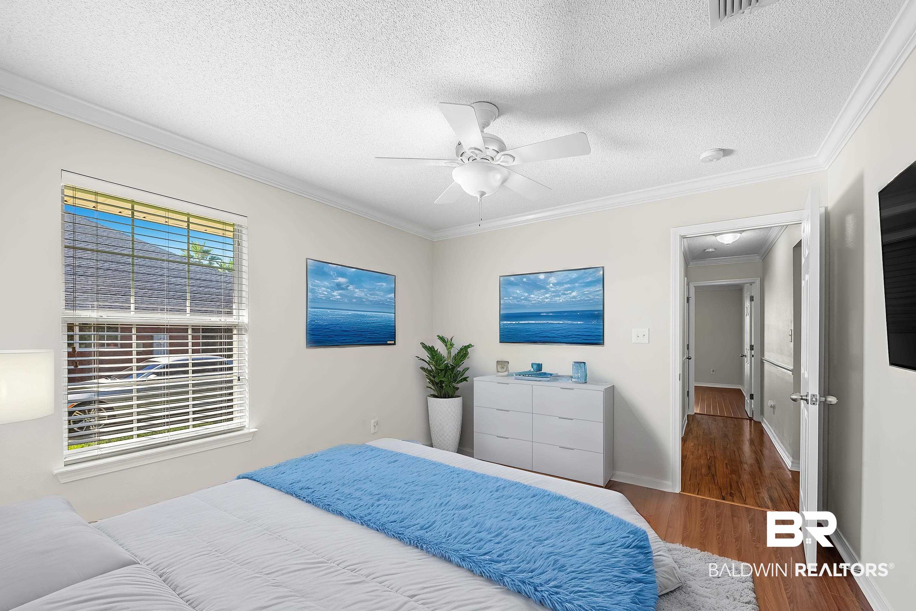 421 Collinwood Loop Foley, AL 36535 - Photo 62 of 62 Bedroom featuring ceiling fan, multiple windows, dark hardwood / wood-style floors, and a textured ceiling