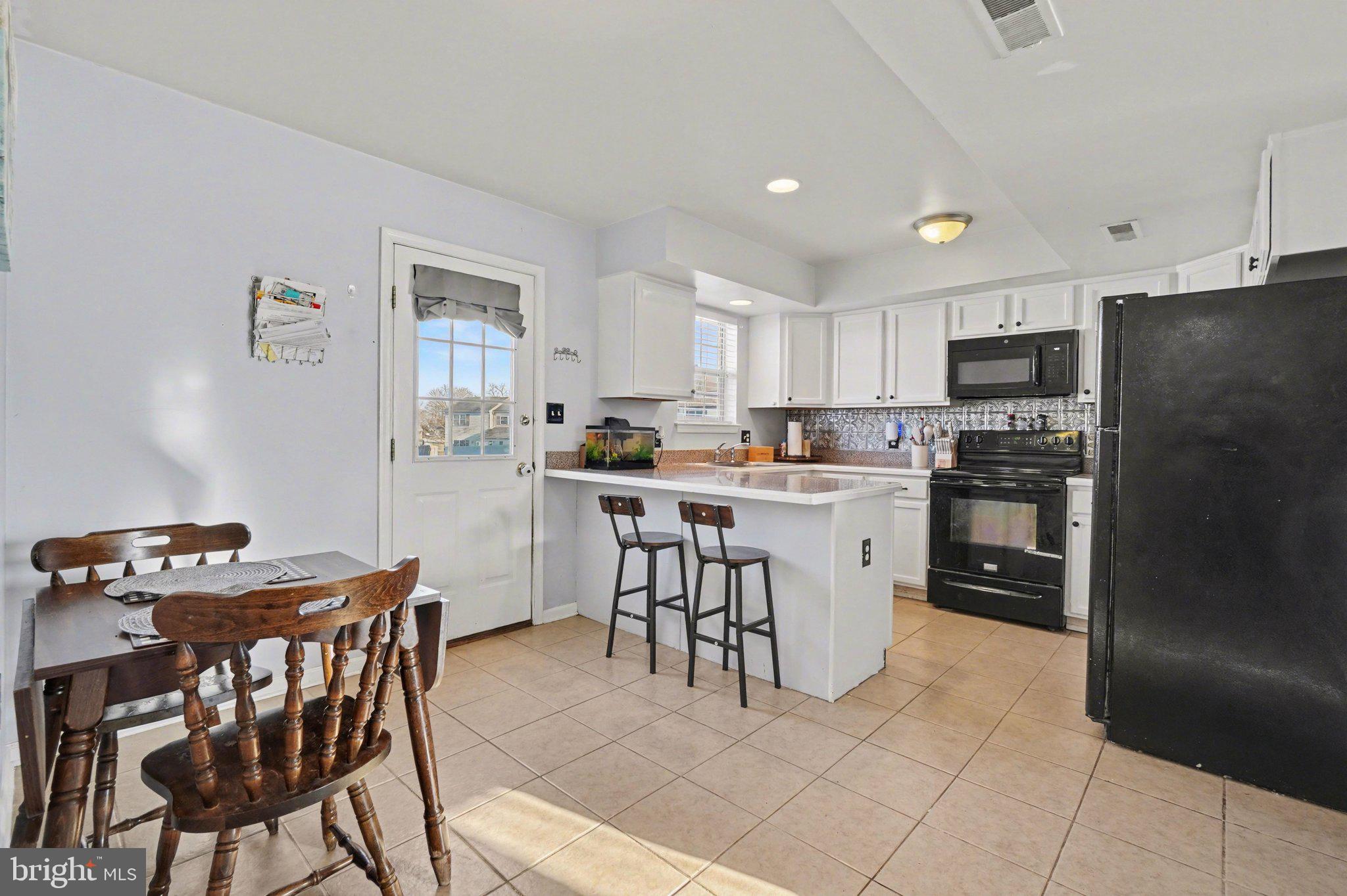 2941 Milky Way Dover, PA 17315 - Photo 8 of 26 a kitchen with a dining table chairs and refrigerator