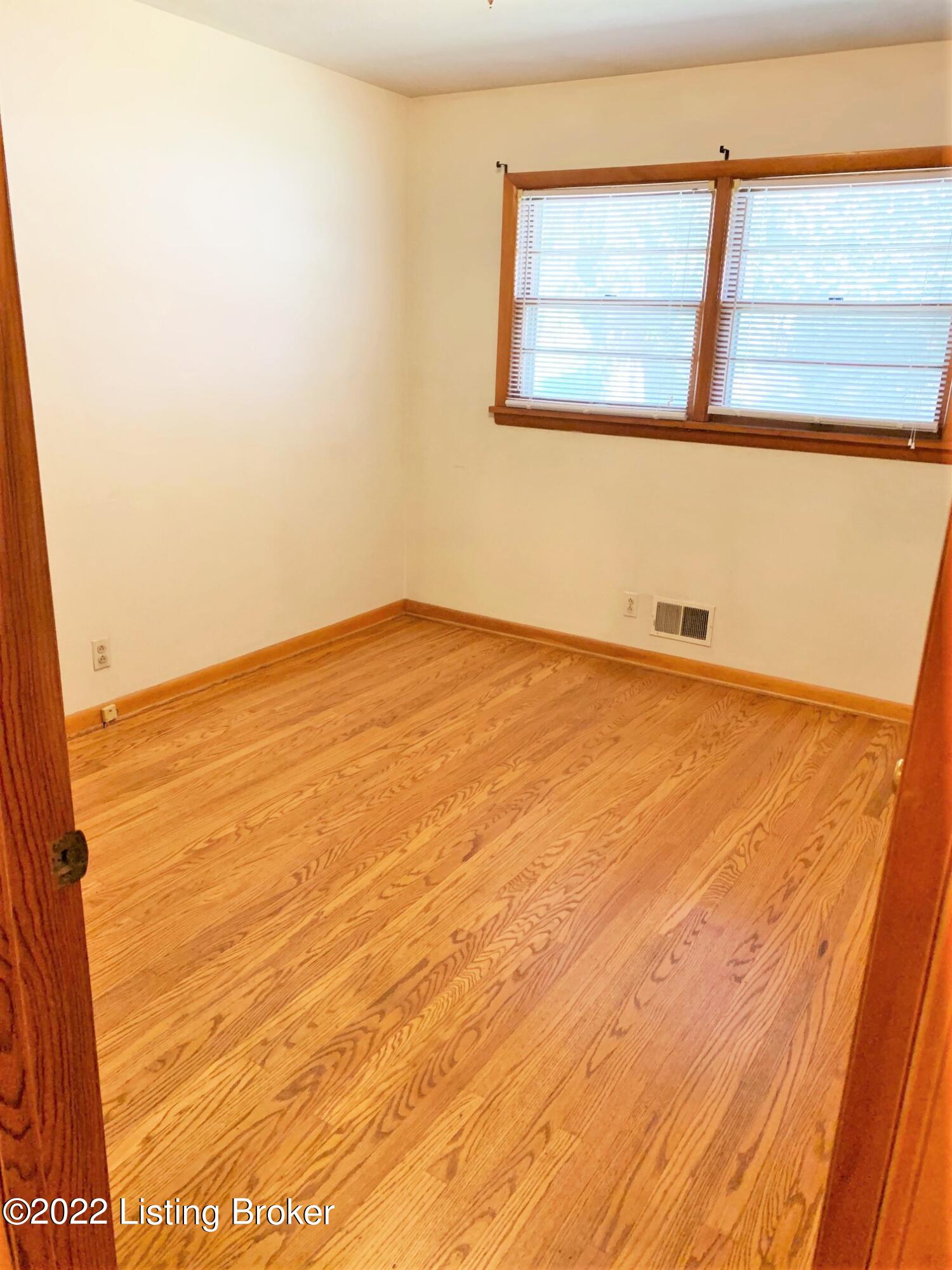 7002 Ledgerock Road Louisville, KY 40219 - Photo 17 of 28 Front middle bedroom w/refinished hardwood flooring.