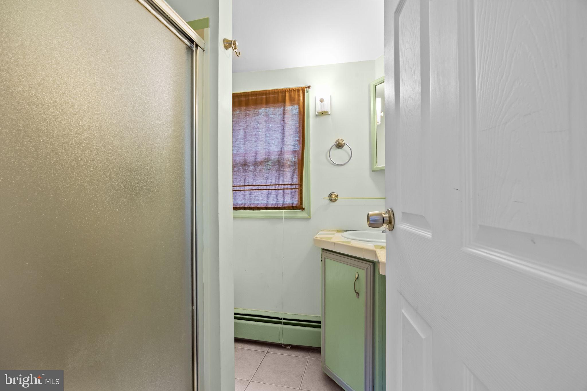 36 Grapevine Road Levittown, PA 19057 - Photo 12 of 19 a bathroom with a sink a toilet and shower