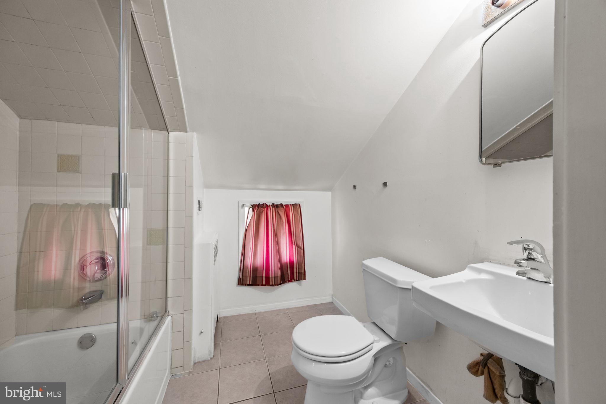 36 Grapevine Road Levittown, PA 19057 - Photo 13 of 19 a bathroom with a toilet sink and shower curtain