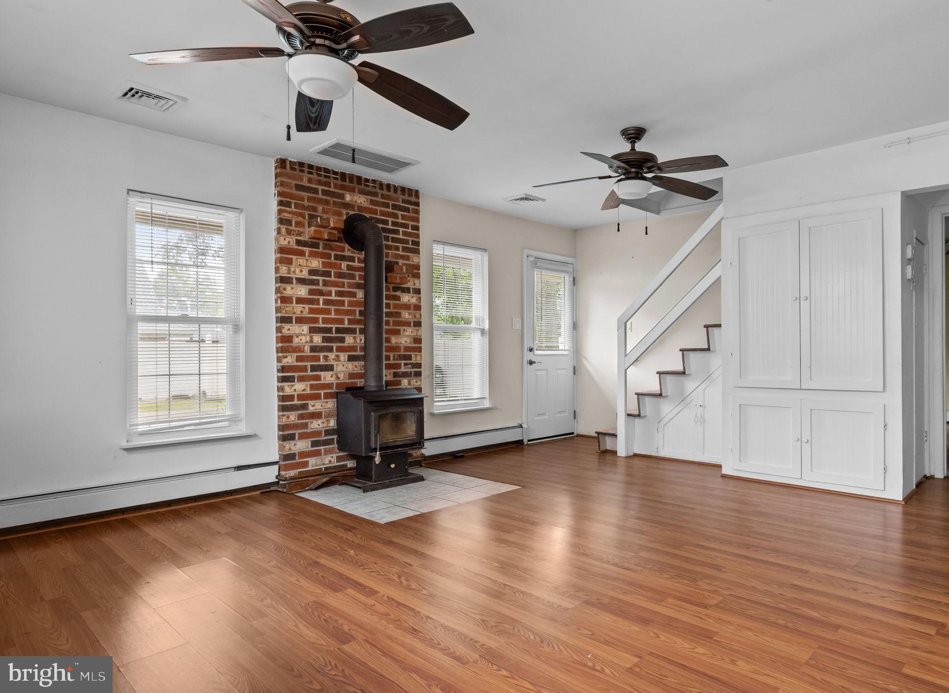 36 Grapevine Road Levittown, PA 19057 - Photo 4 of 19 a view of an empty room with a window and wooden floor