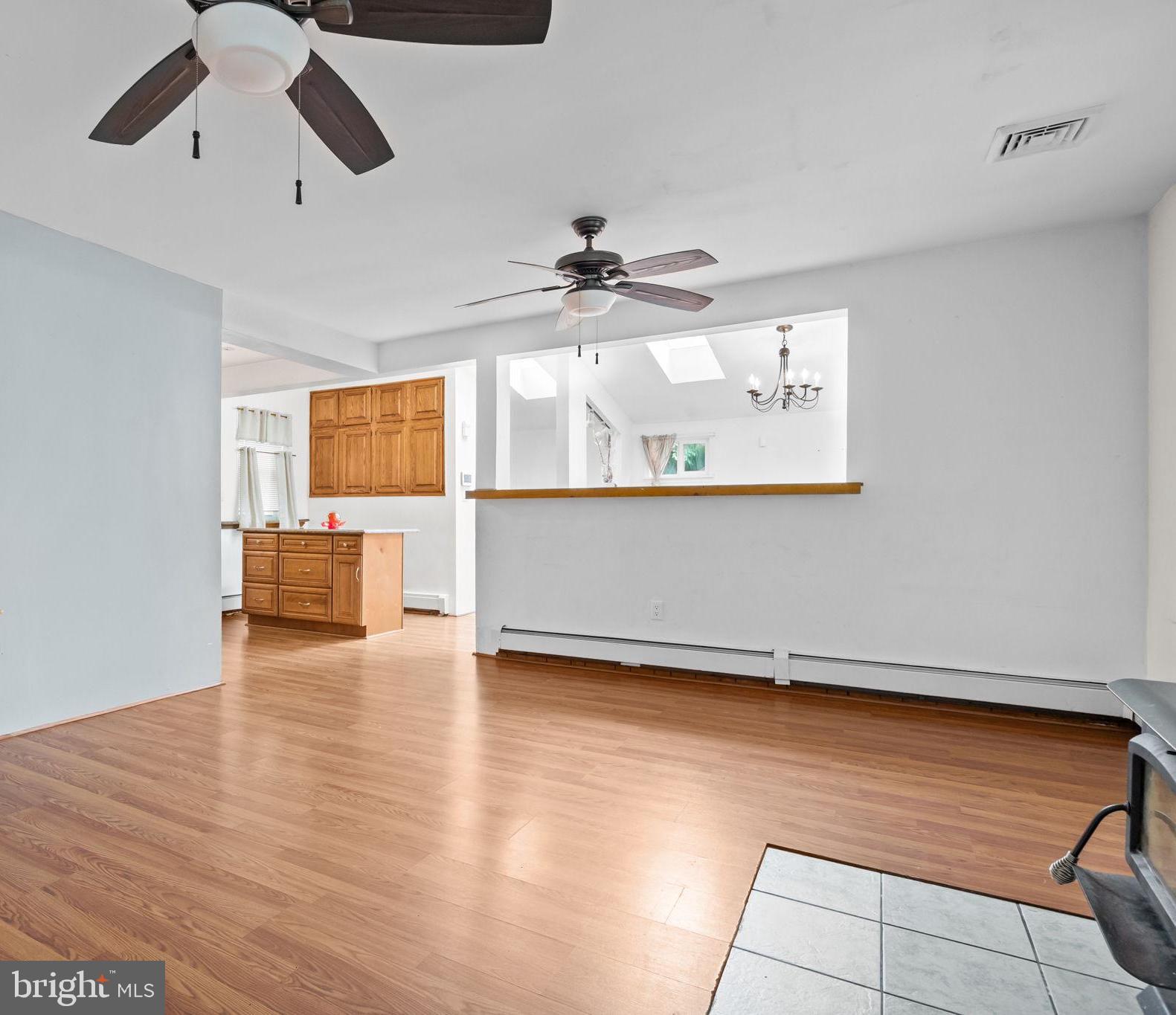 36 Grapevine Road Levittown, PA 19057 - Photo 6 of 19 a view of a room with wooden floor a ceiling fan and windows