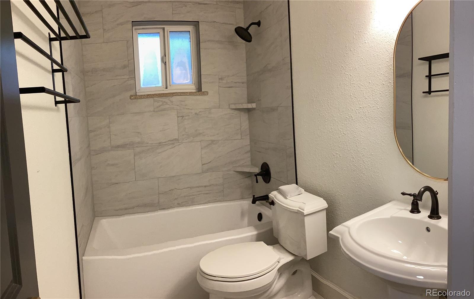 2463 South Corona Street Denver, CO 80210 - Photo 6 of 10 a bathroom with a sink toilet and shower
