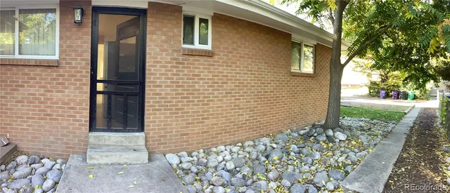 a view of a brick house with a large window