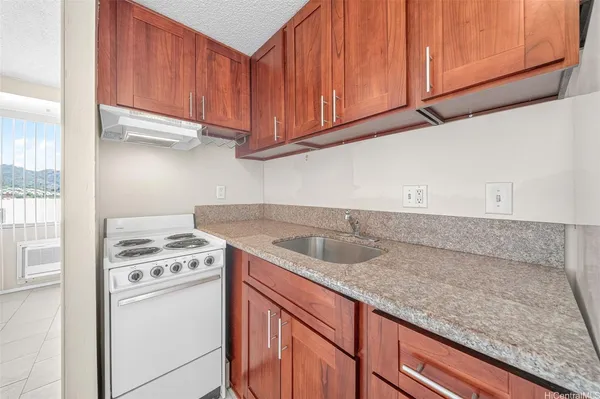 a kitchen with stainless steel appliances granite countertop a sink a refrigerator and cabinets