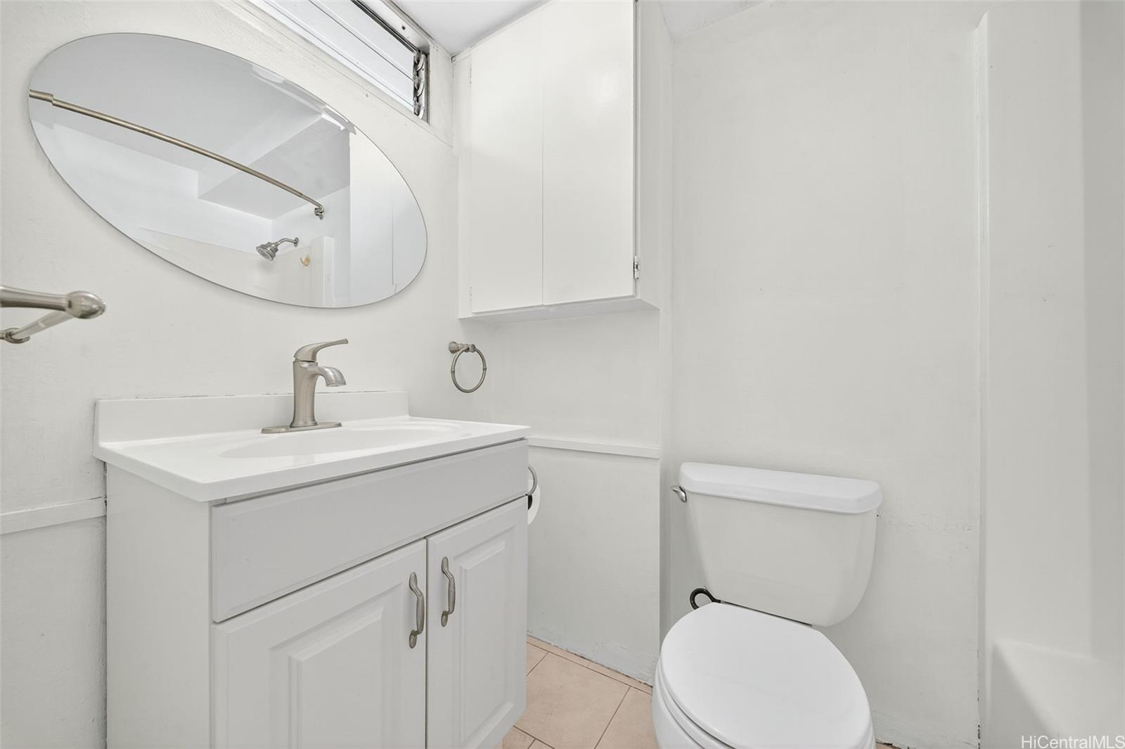 2888 Ala Ilima Street, Unit 1512 Honolulu, HI 96818 - Photo 14 of 25 a bathroom with a toilet sink vanity and mirror