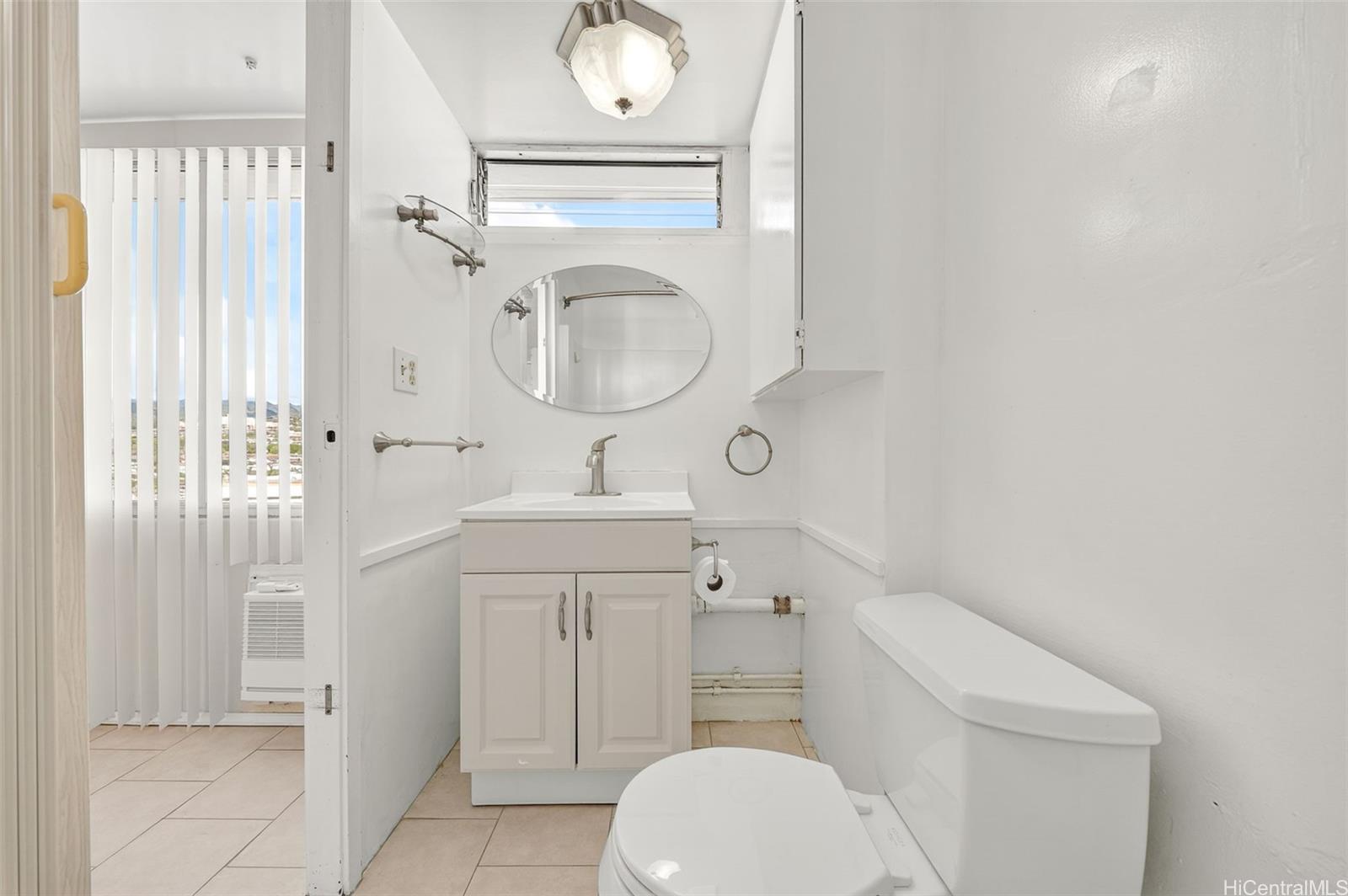 2888 Ala Ilima Street, Unit 1512 Honolulu, HI 96818 - Photo 15 of 25 a bathroom with a toilet sink vanity and mirror