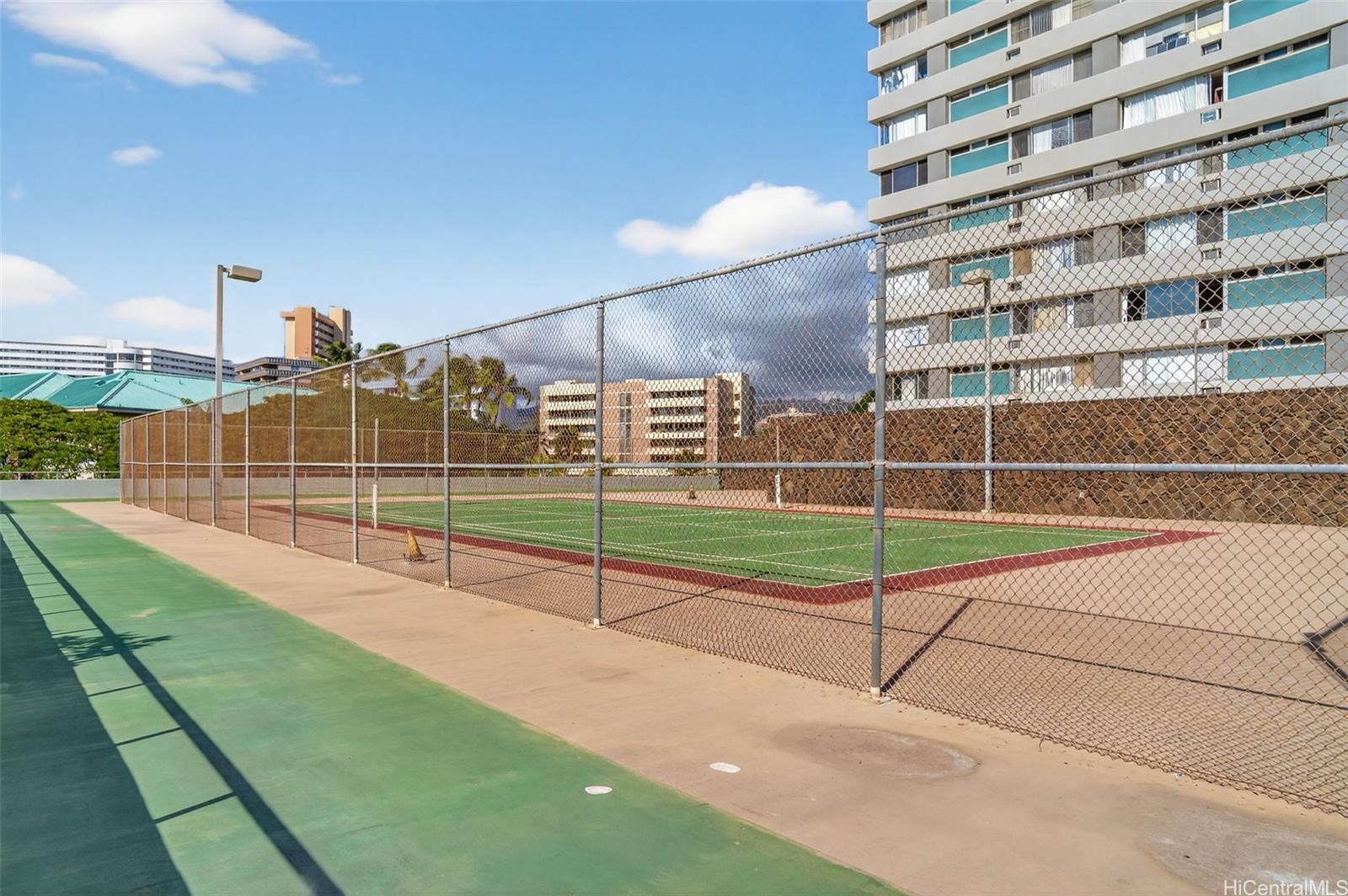 2888 Ala Ilima Street, Unit 1512 Honolulu, HI 96818 - Photo 24 of 25 a view of a tennis ground with tall buildings in the background