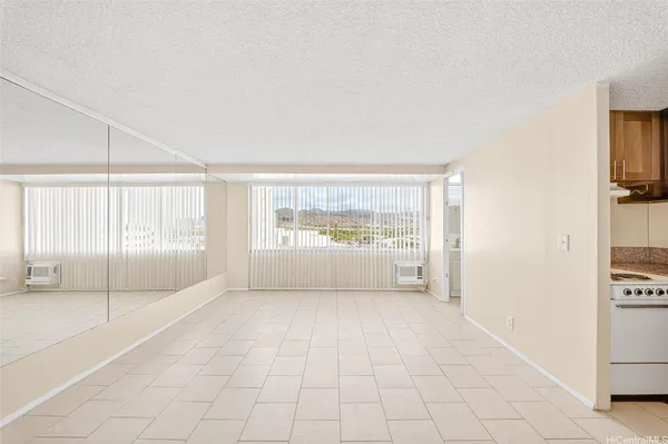 a big room with wooden floor and windows