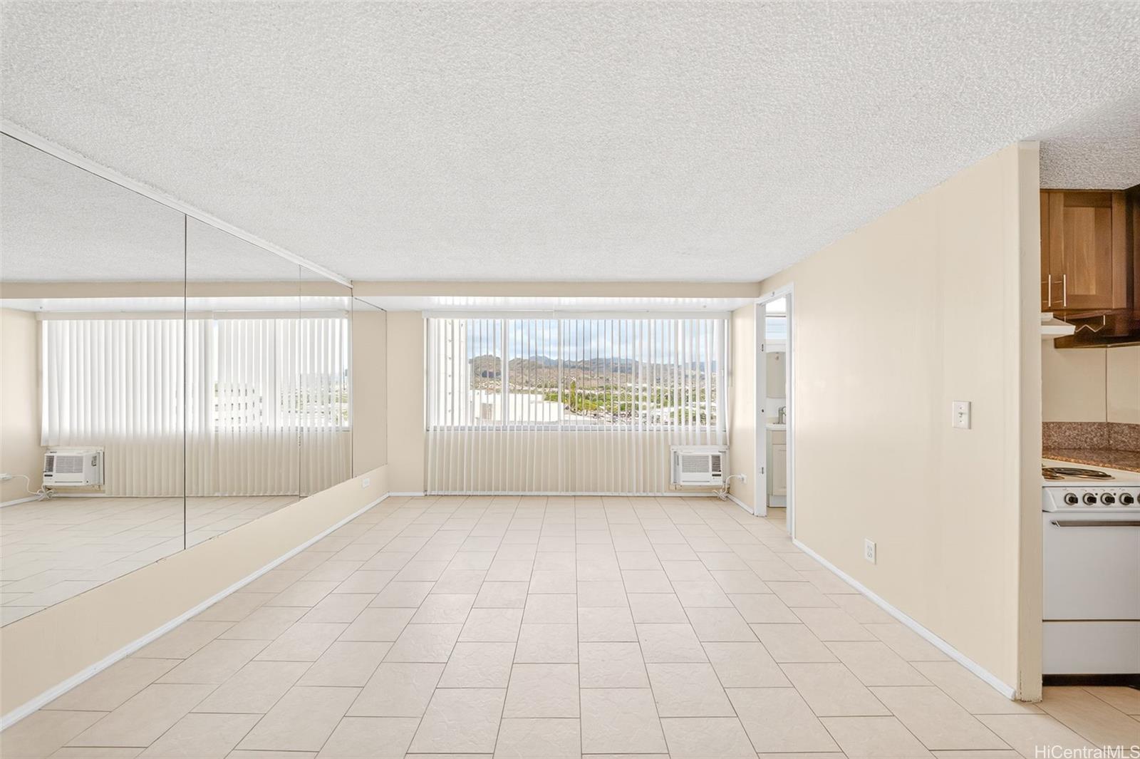 2888 Ala Ilima Street, Unit 1512 Honolulu, HI 96818 - Photo 4 of 25 a big room with wooden floor and windows