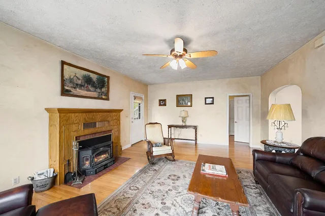 a view of a hallway with a livingroom and entryway
